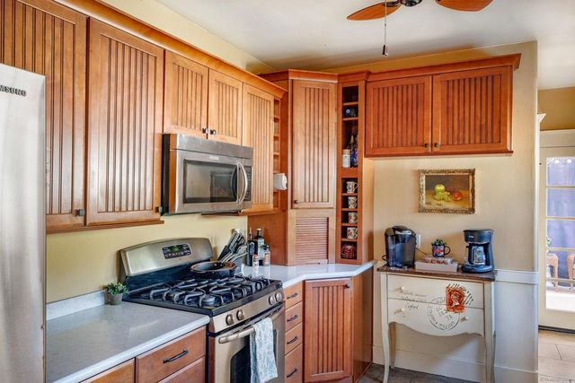 a kitchen with stainless steel appliances granite countertop a stove and a refrigerator