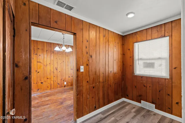 a view of a livingroom with wooden floor and a window