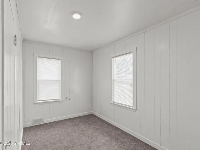 an empty room with windows