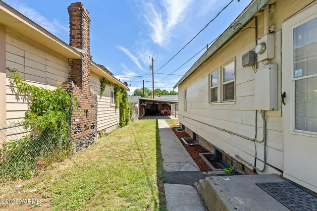 a yellow house with trees in front of it