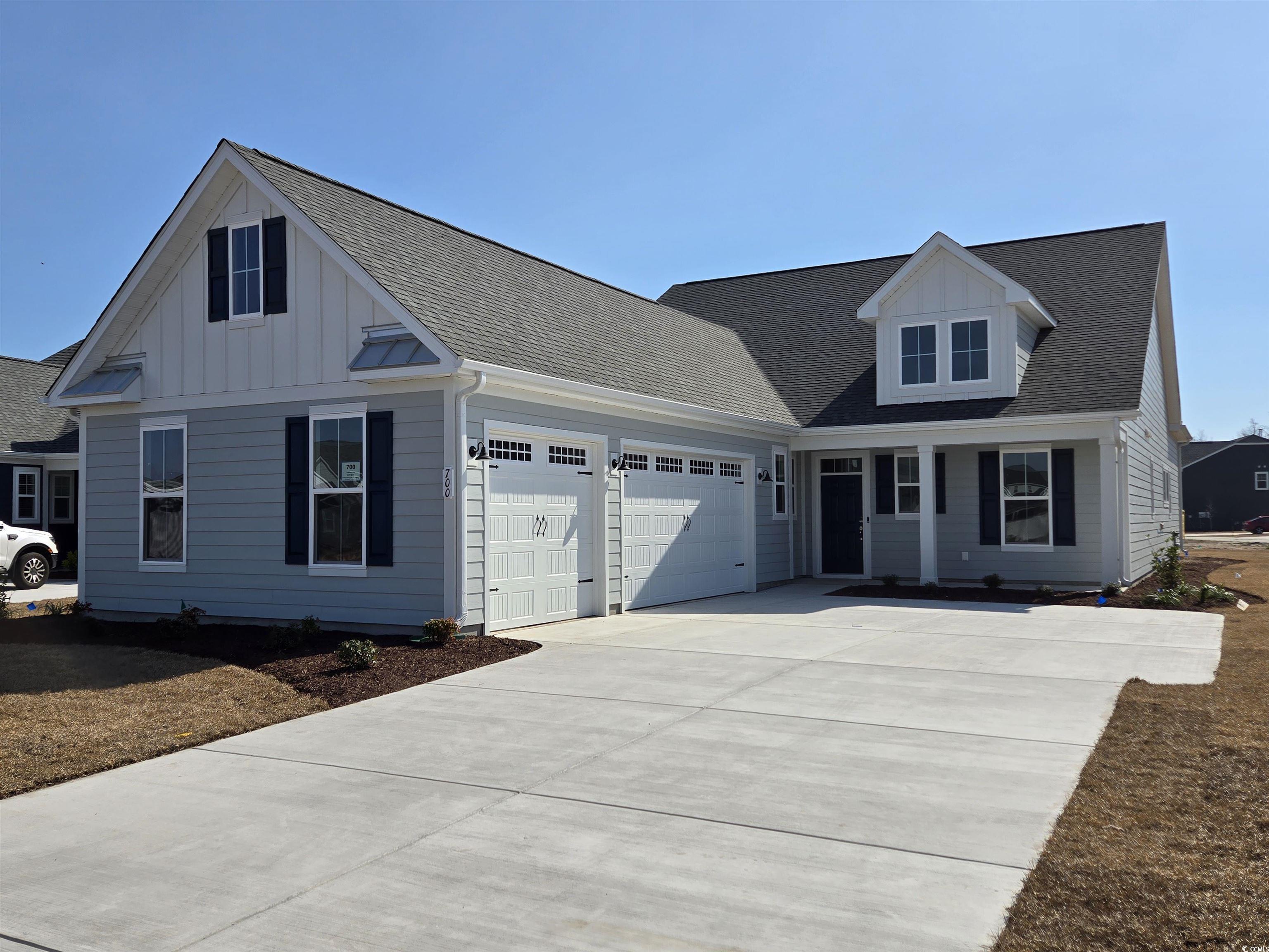View of front of property with a garage, driveway,