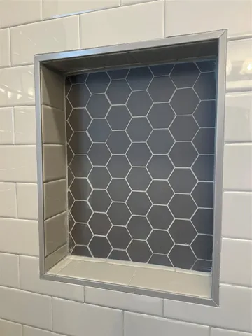 a bathroom with a shower and a window