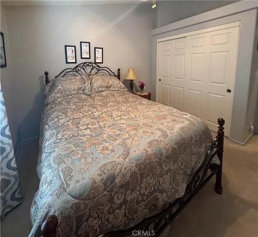 a bed sitting in a bedroom next to a window