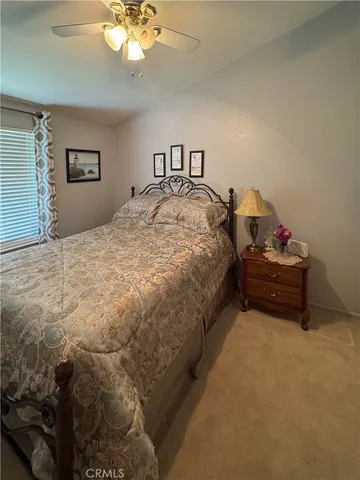 a spacious bedroom with a bed and a chandelier