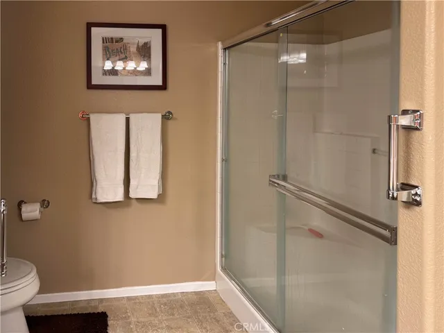 a bathroom with a toilet and a shower