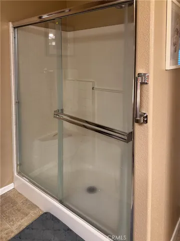 a bathroom with a glass shower door