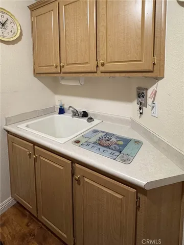 a kitchen with a sink cabinets and a window
