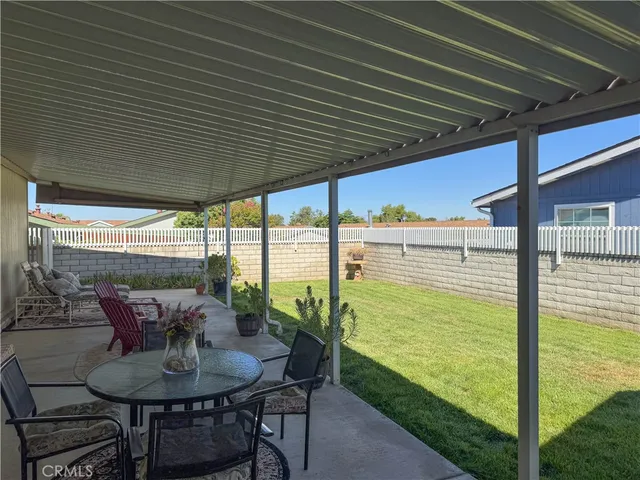 a backyard of a house with yard table and chairs