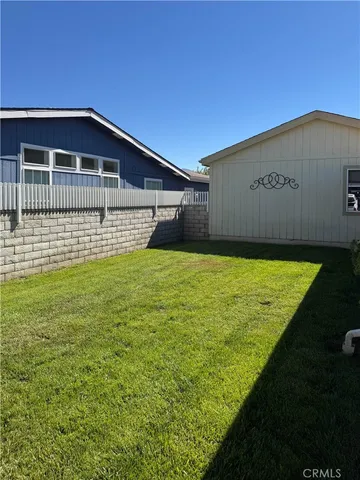 a view of a house with a swimming pool and sitting area