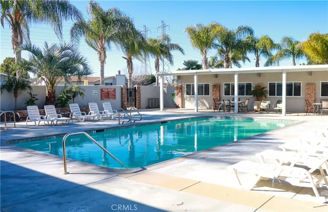 a view of a patio with table and chairs potted plants
