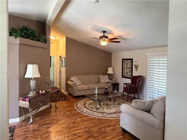 a living room with furniture a rug and a lamp
