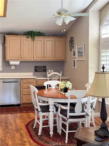 a kitchen with granite countertop a table chairs stove and cabinets