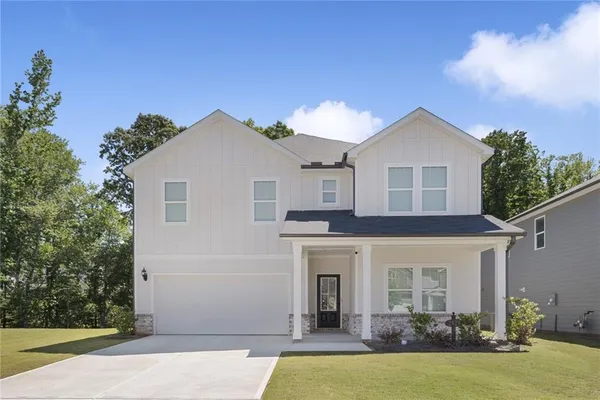 a front view of a house with a yard