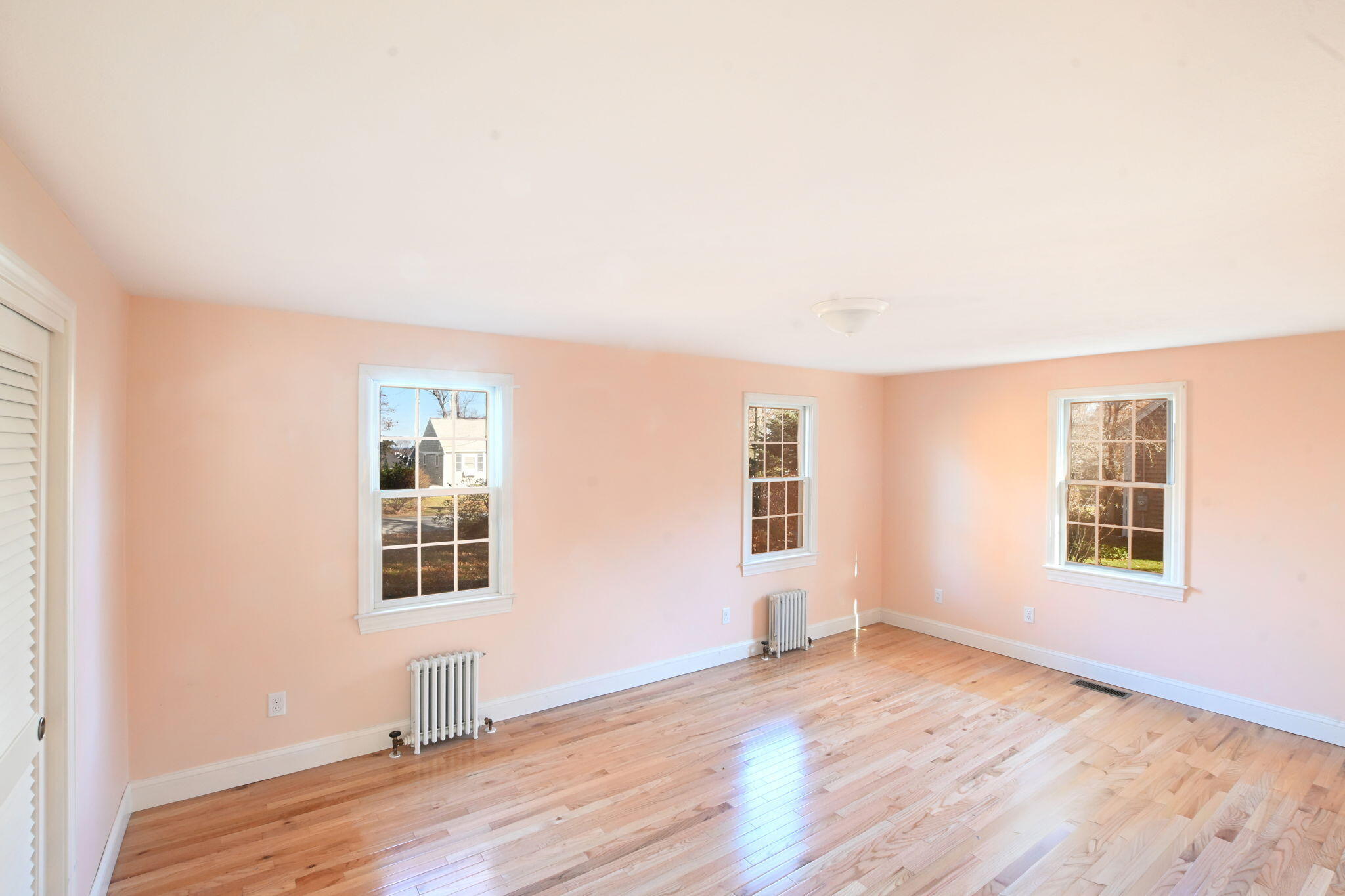 12 Crowell Road Sandwich, MA 02563 - Photo 13 of 49 an empty room with wooden floor and windows