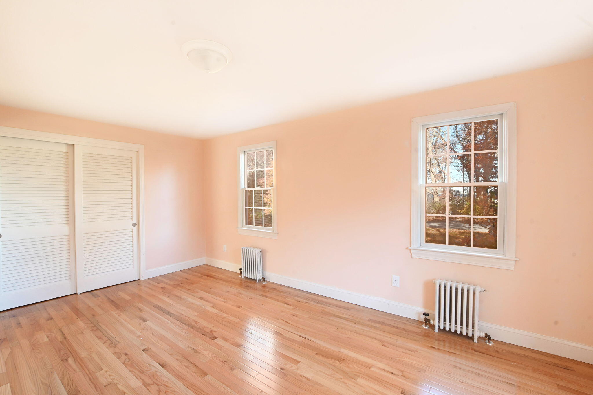 12 Crowell Road Sandwich, MA 02563 - Photo 15 of 49 an empty room with wooden floor and windows