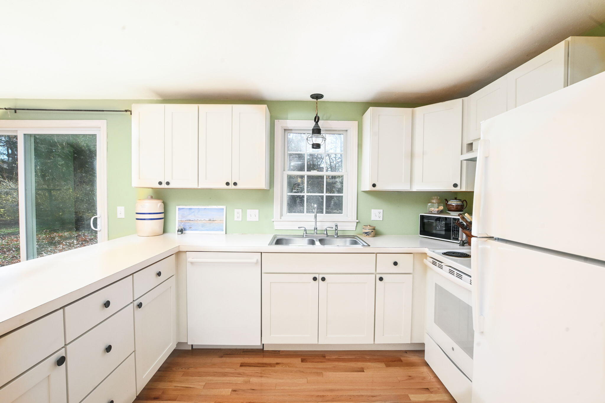 12 Crowell Road Sandwich, MA 02563 - Photo 24 of 49 a kitchen with granite countertop white cabinets white appliances a sink and a window