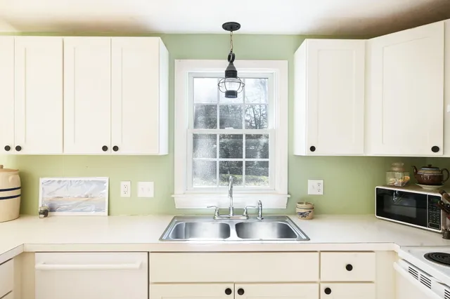 a kitchen with a sink and a window