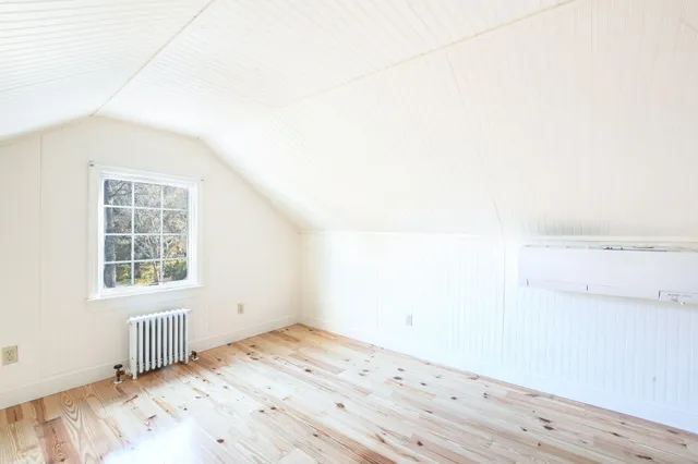 a bedroom with a bed and a night stand