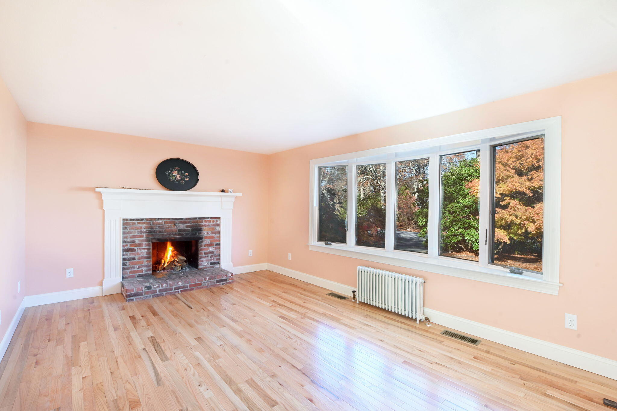 12 Crowell Road Sandwich, MA 02563 - Photo 5 of 49 wooden floor fireplace and windows in an empty room