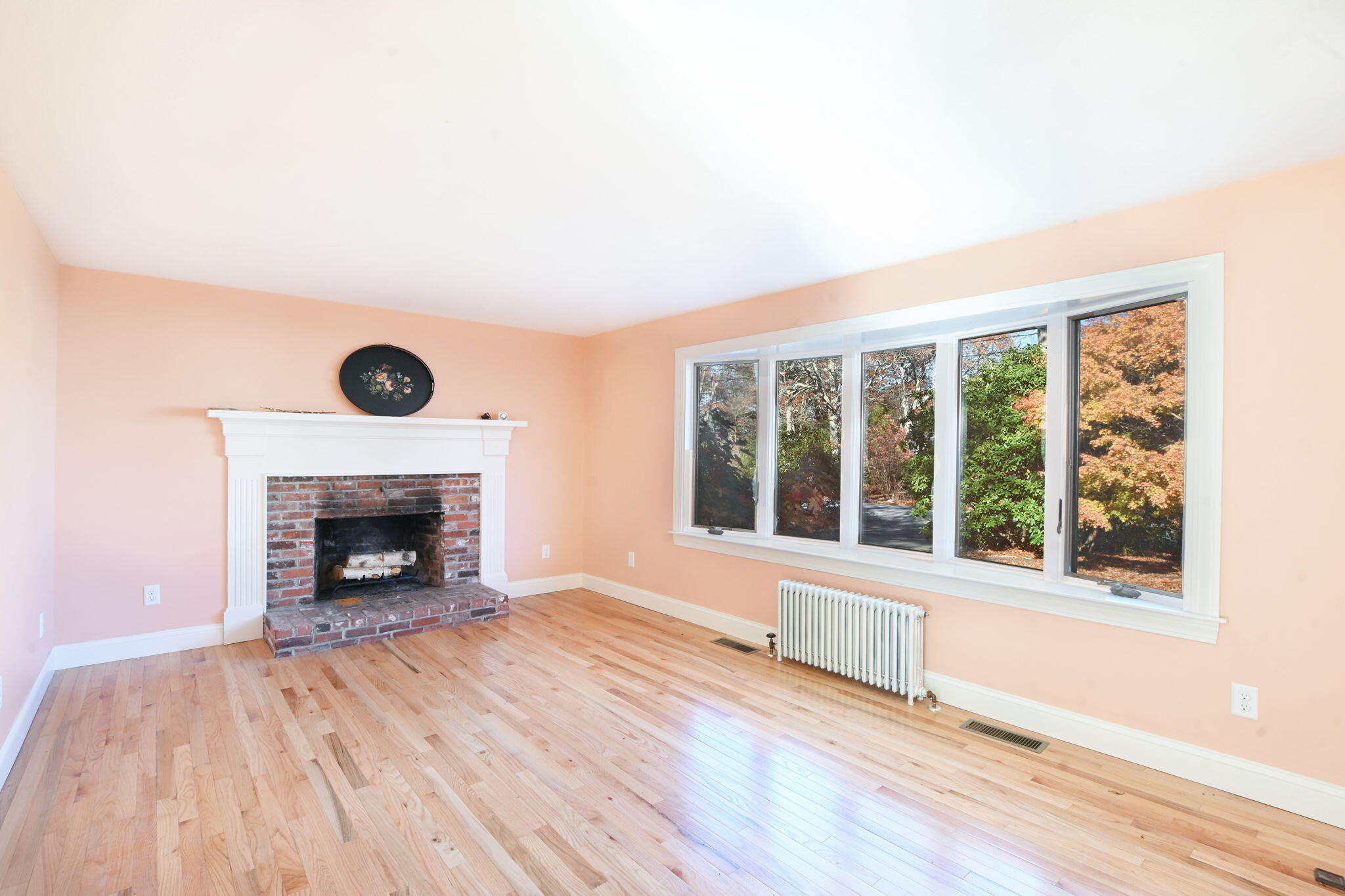 12 Crowell Road Sandwich, MA 02563 - Photo 6 of 49 wooden floor fireplace and windows in an empty room