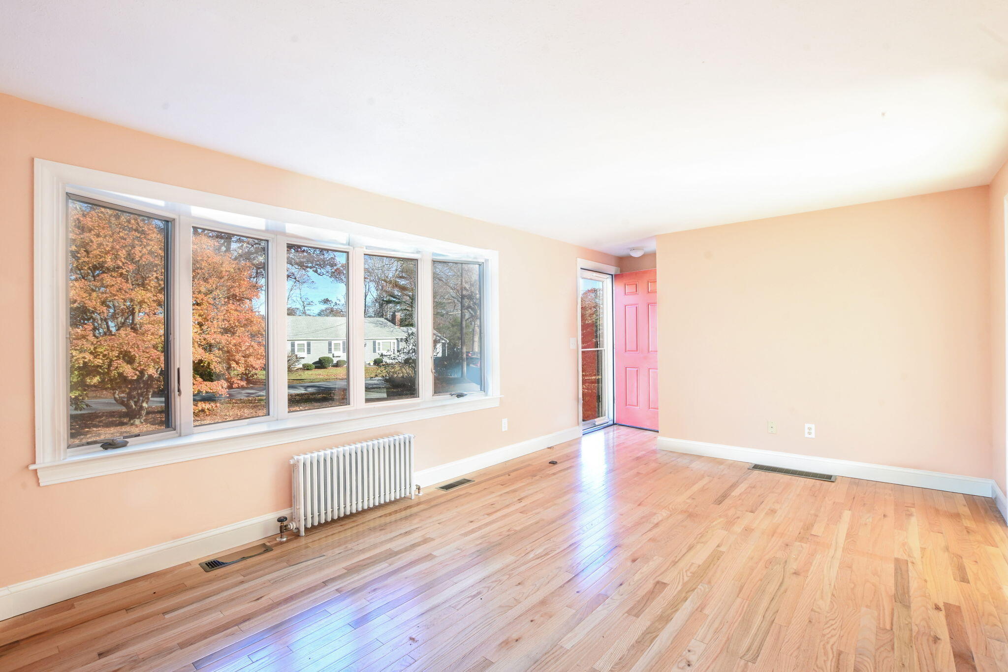 12 Crowell Road Sandwich, MA 02563 - Photo 9 of 49 a view of an empty room with wooden floor and a window