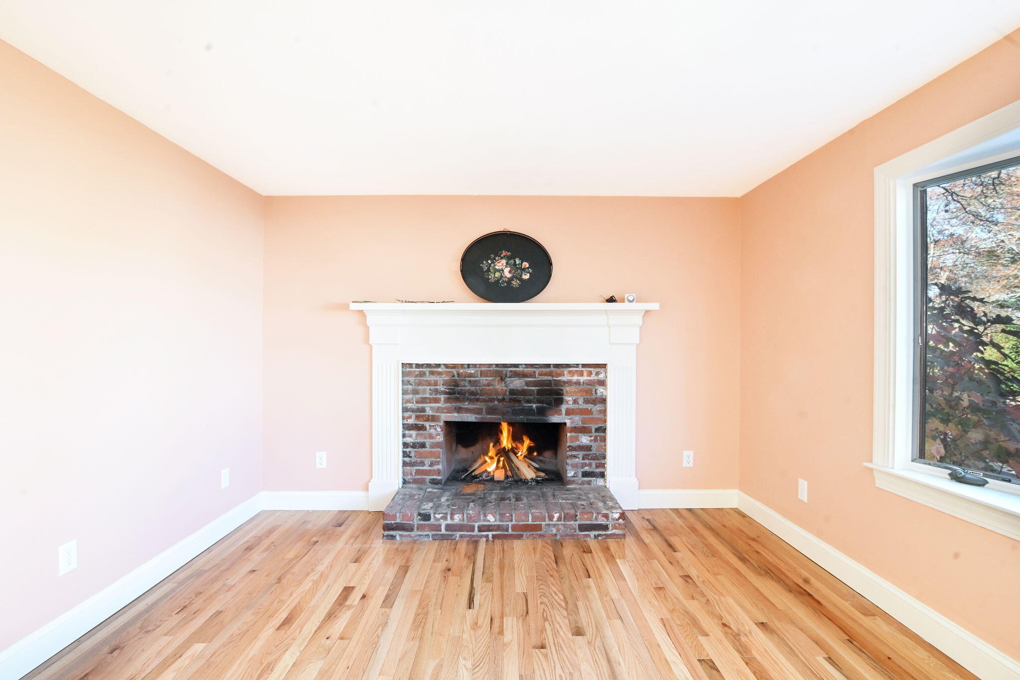 12 Crowell Road Sandwich, MA 02563 - Photo 10 of 49 a living room with a fireplace and a wooden floor