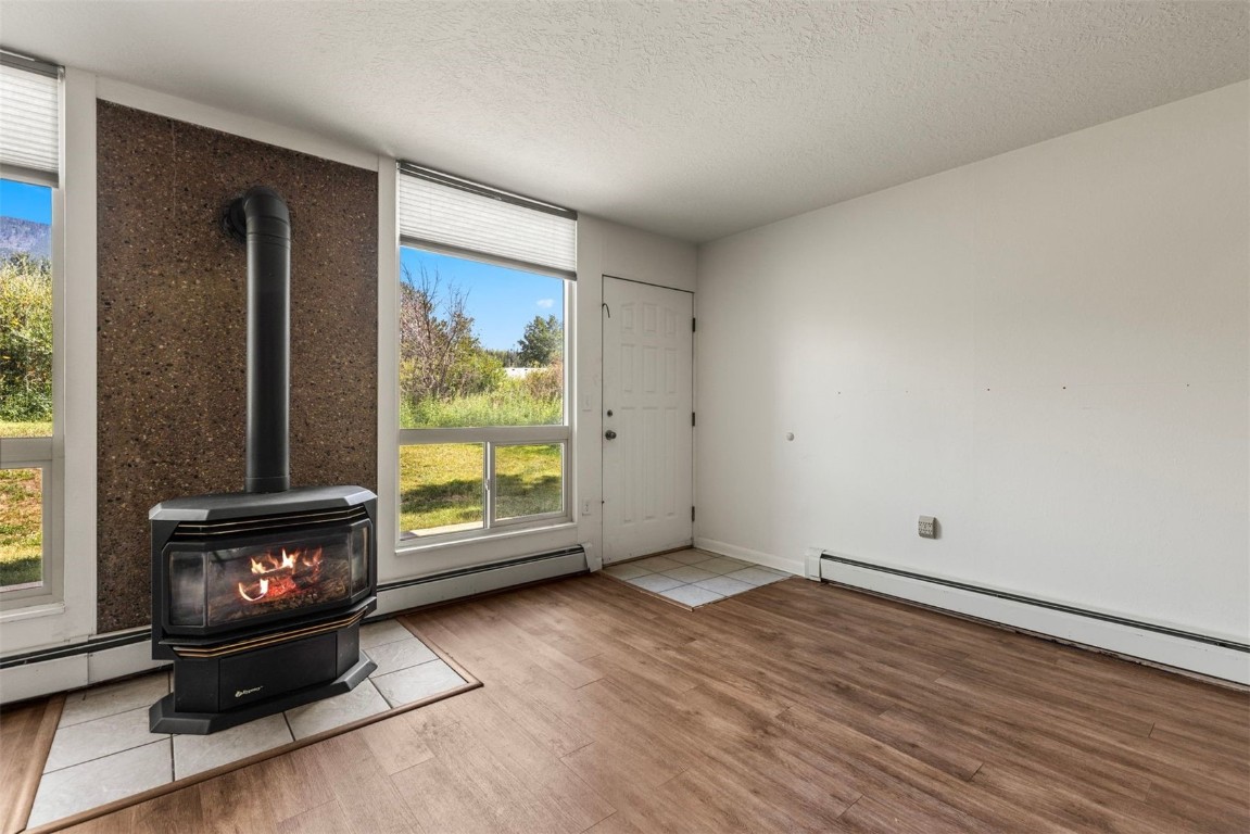 390 Straight Creek Drive, Unit 307 Dillon, CO 80435 - Photo 13 of 35 a view of an empty room with a fireplace and a window