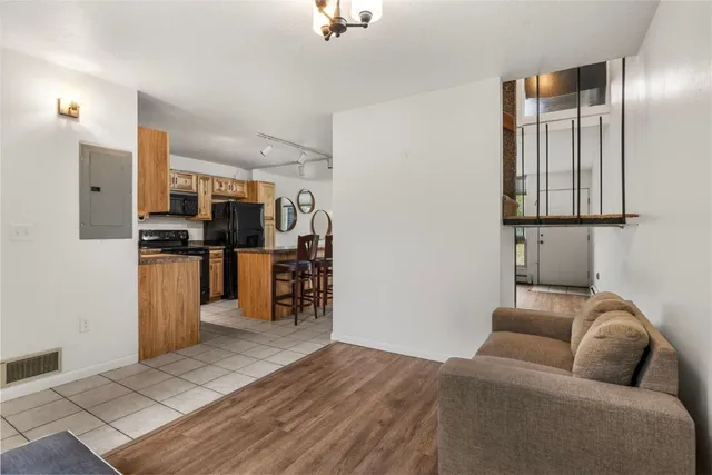 a living room with furniture and kitchen view