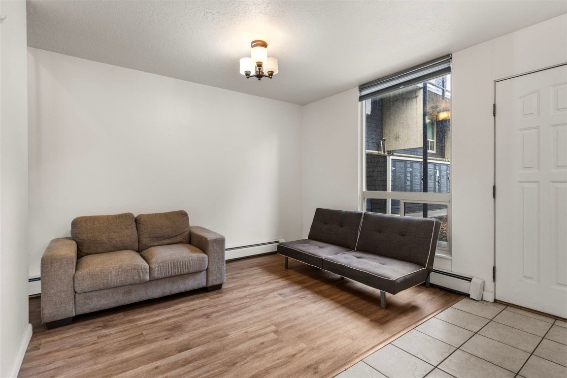 390 Straight Creek Drive, Unit 307 Dillon, CO 80435 - Photo 16 of 35 a living room with furniture and a wooden floor