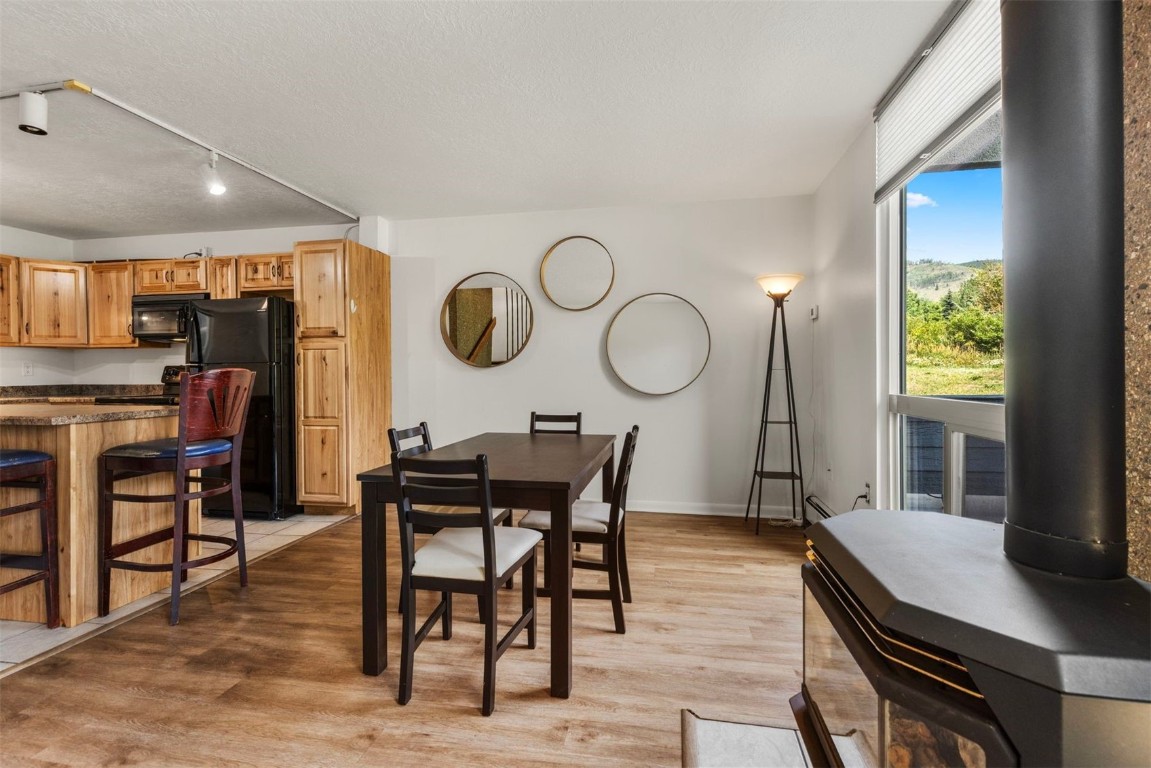 390 Straight Creek Drive, Unit 307 Dillon, CO 80435 - Photo 4 of 35 a view of a dining room with furniture window and wooden floor