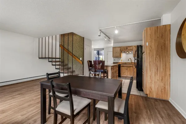 a dining room with furniture and wooden floor