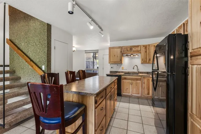 a kitchen with cabinets and refrigerator