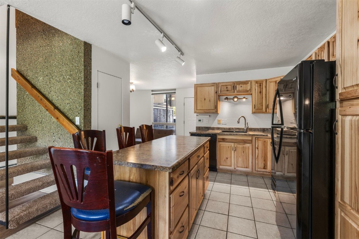 390 Straight Creek Drive, Unit 307 Dillon, CO 80435 - Photo 6 of 35 a kitchen with cabinets and refrigerator