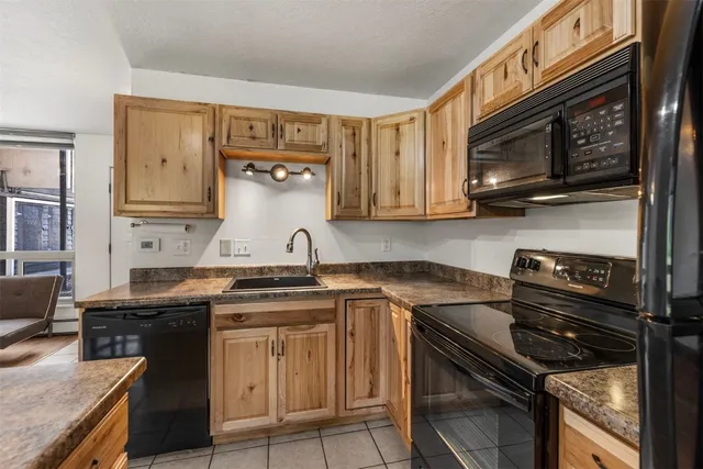 a kitchen with stainless steel appliances granite countertop a stove and a microwave