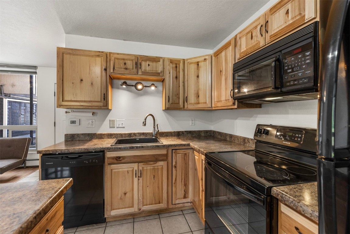 390 Straight Creek Drive, Unit 307 Dillon, CO 80435 - Photo 8 of 35 a kitchen with stainless steel appliances granite countertop a stove and a microwave