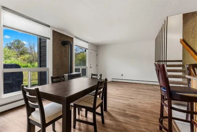 a view of a dining room with furniture and window