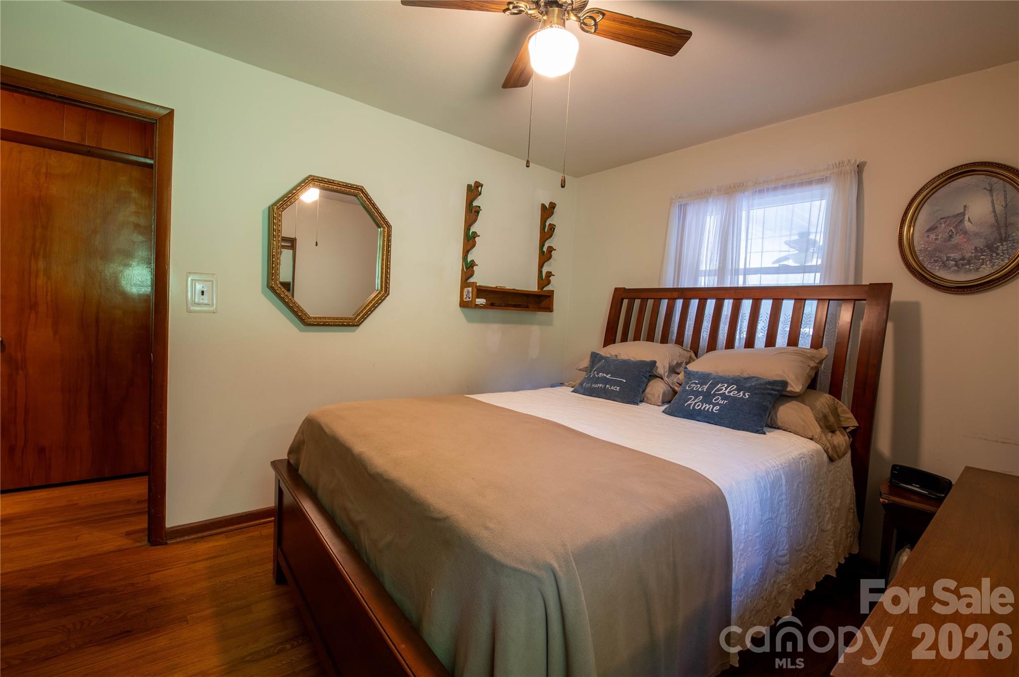 40 Double Island Road Burnsville, NC 28714 - Photo 27 of 38 a bedroom with a bed and a chandelier