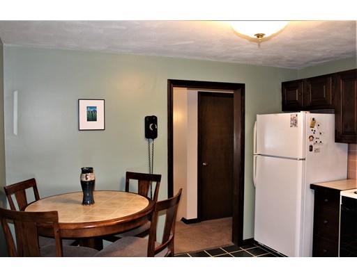 8 Meadowbrook Road Franklin, MA 02038 - Photo 5 of 11 a dining room with a table and a refrigerator