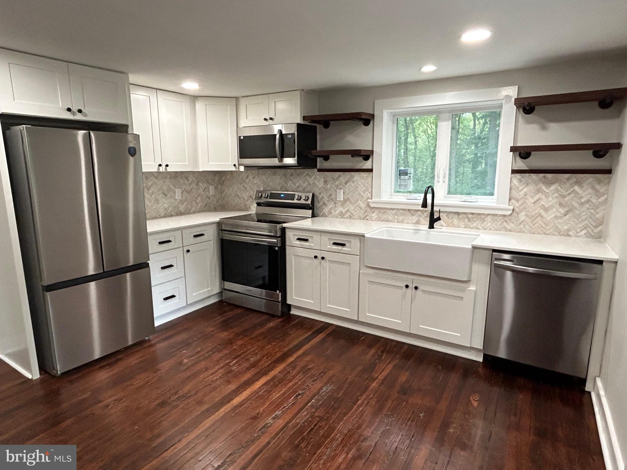 1355 Penn Grant Road, Unit 2 Strasburg, PA 17579 - Photo 2 of 13 a kitchen with stainless steel appliances a refrigerator sink and microwave