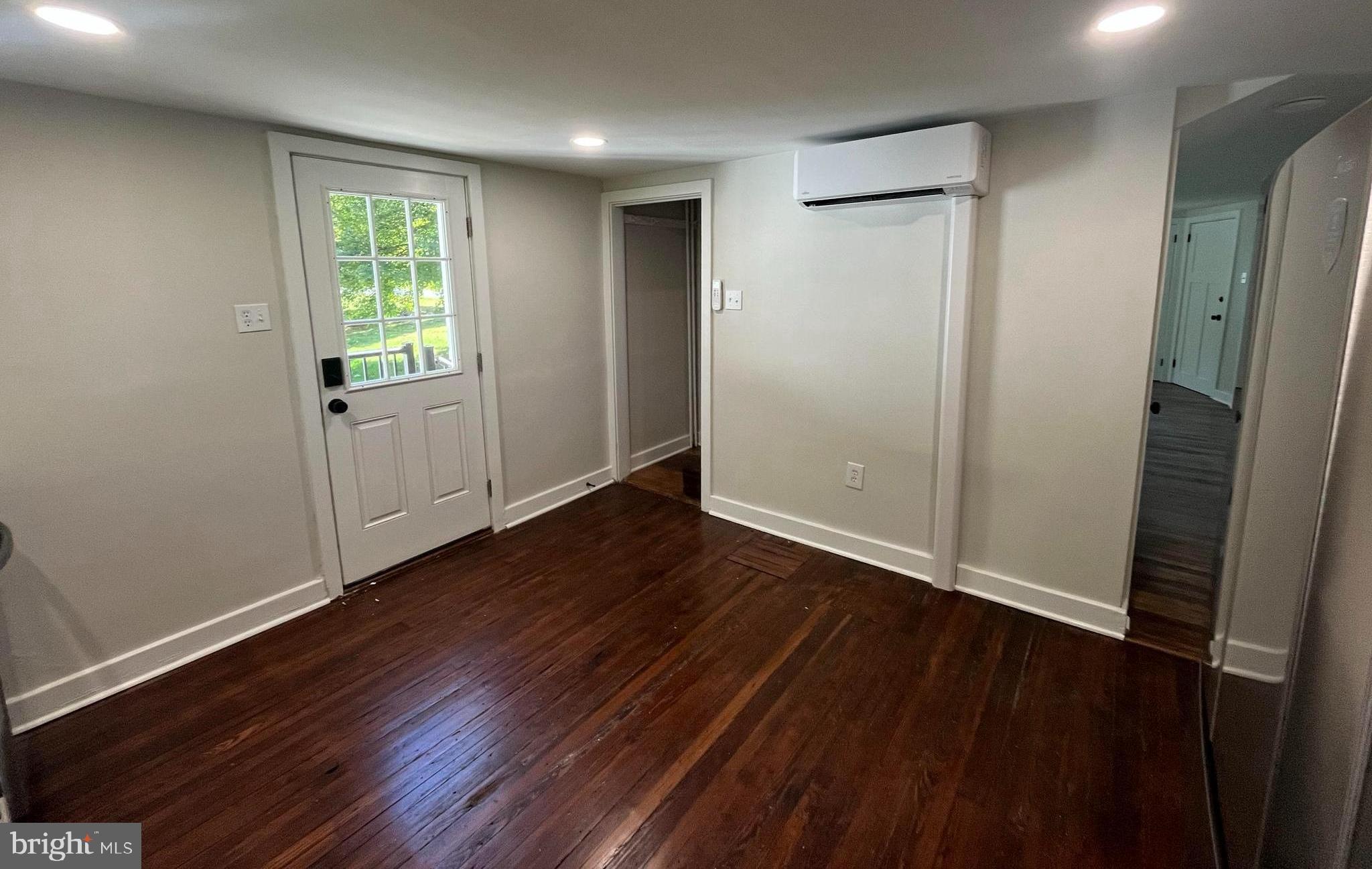1355 Penn Grant Road, Unit 2 Strasburg, PA 17579 - Photo 3 of 13 an empty room with wooden floor and windows