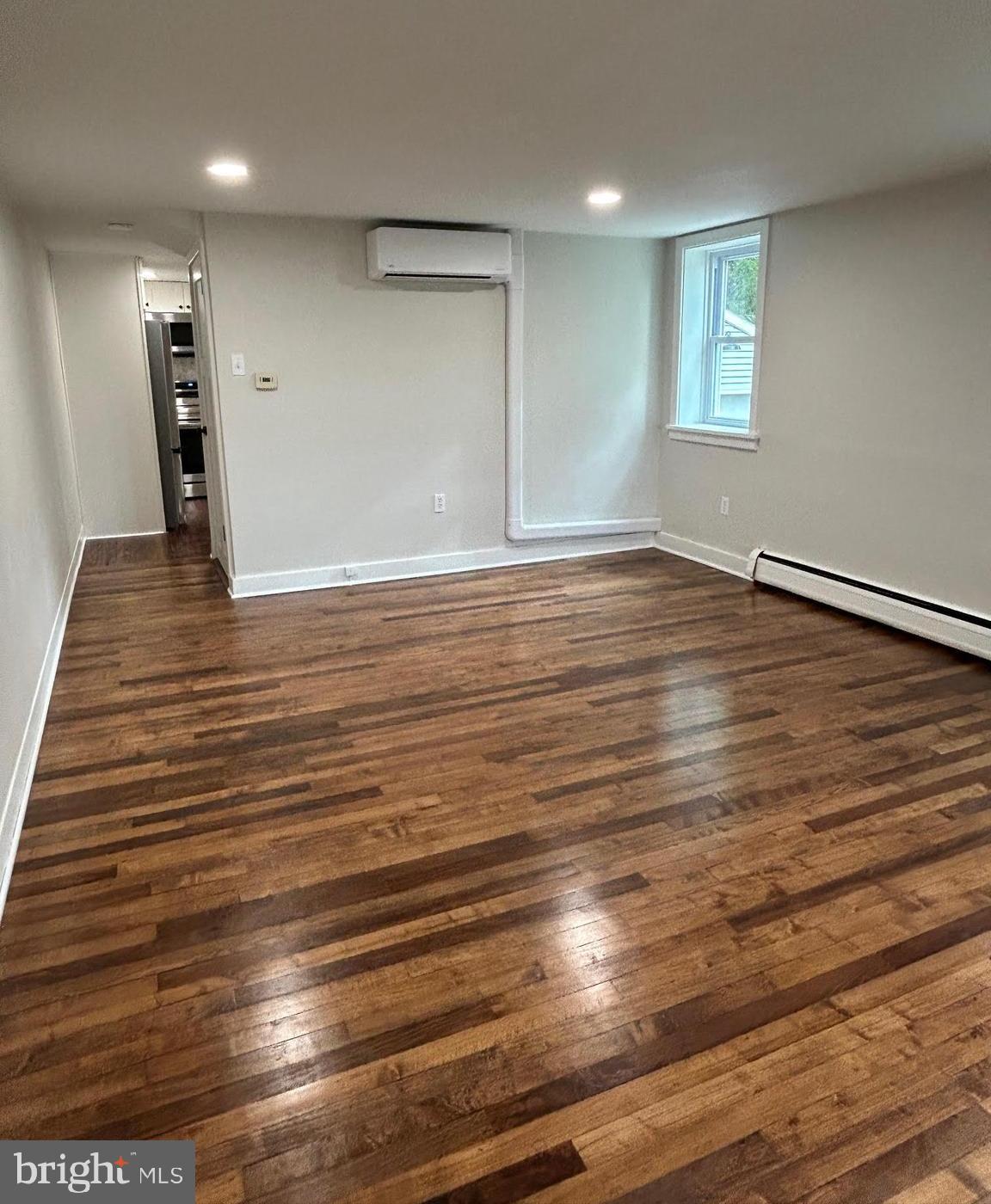 1355 Penn Grant Road, Unit 2 Strasburg, PA 17579 - Photo 4 of 13 an empty room with wooden floor and windows