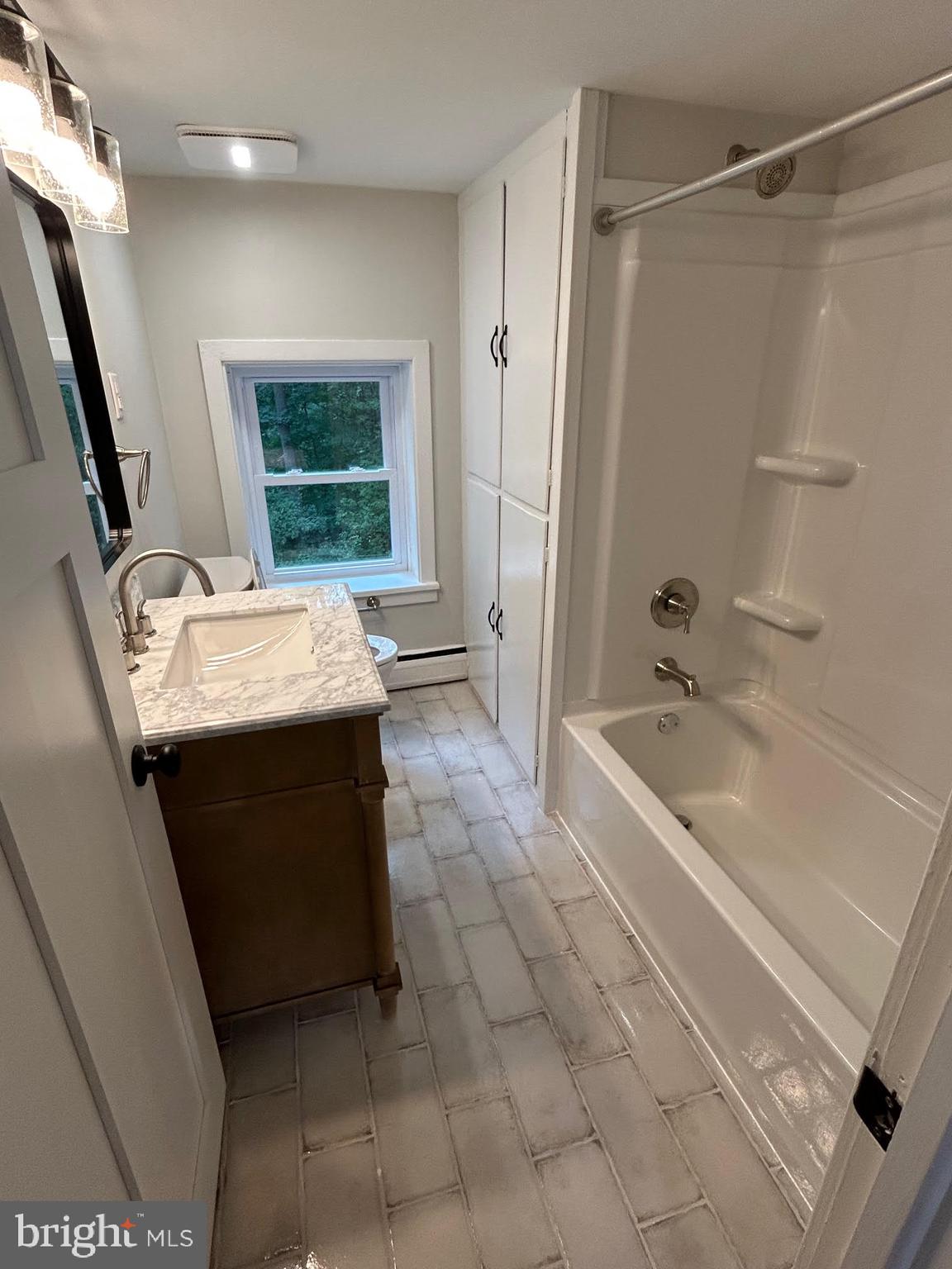 1355 Penn Grant Road, Unit 2 Strasburg, PA 17579 - Photo 9 of 13 a bathroom with a tub sink and mirror