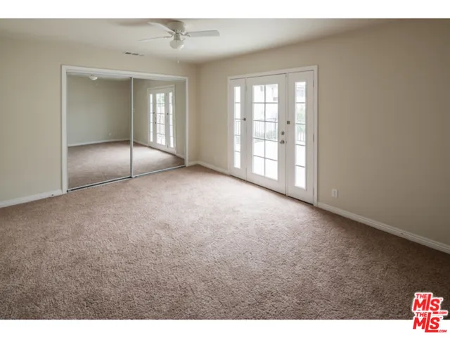 a view of an empty room with glass door
