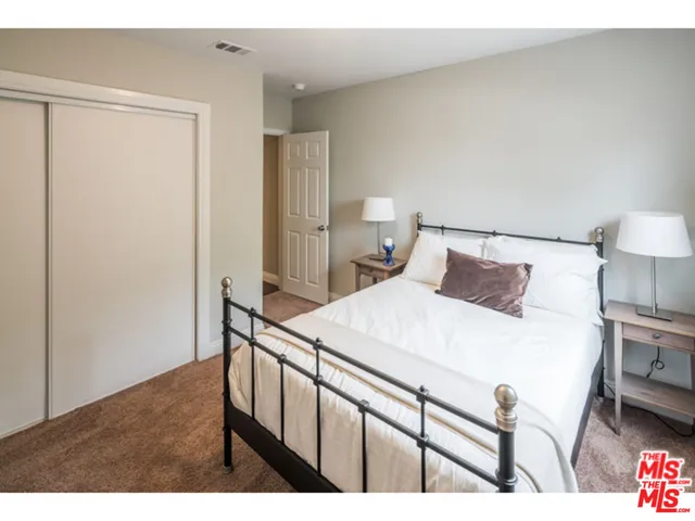 a bedroom with a bed and a table