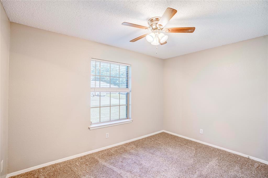 6028 Ridgecrest Drive Watauga, TX 76148 - Photo 29 of 40 an empty room with windows and fan