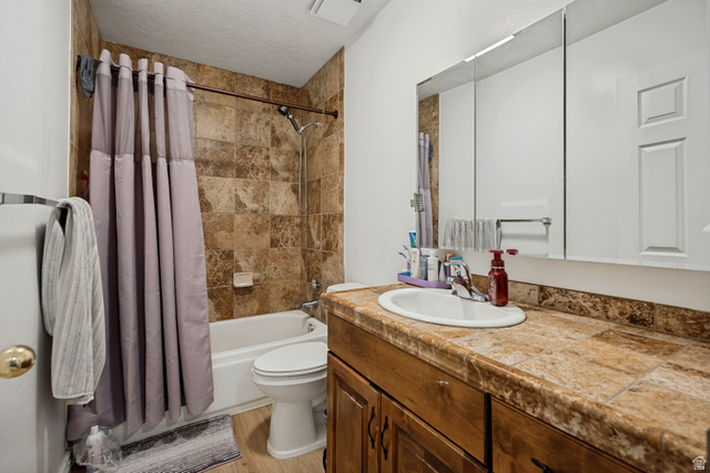 6709 Acoma Road, Unit 239 Midvale, UT 84047 - Photo 13 of 38 6711 -Main level bathroom. Built-in wood-finish vanity with an integrated sink and tiled countertop