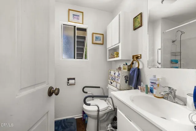 a bathroom with a sink a toilet and mirror
