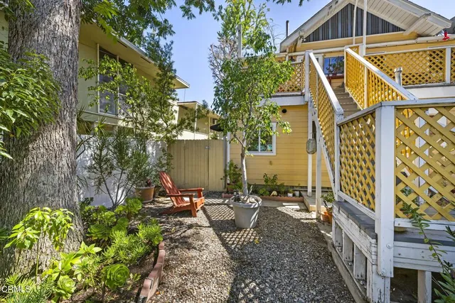 a backyard of a house with table and chairs