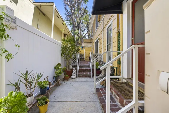 a house with a potted plant on the side