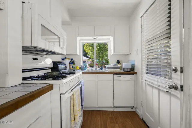a kitchen with a stove a sink and a window